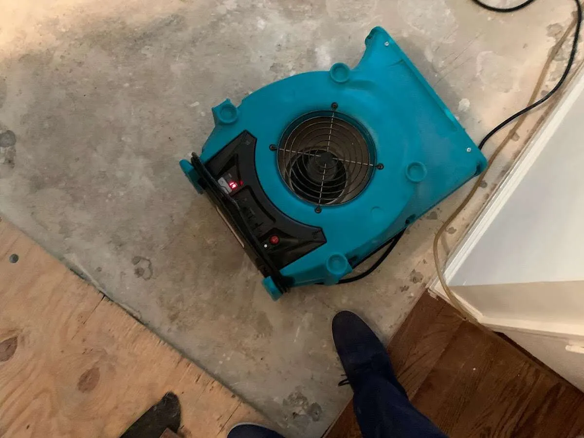Air mover drying subfloor during Commercial Water Damage Restoration in Bagley